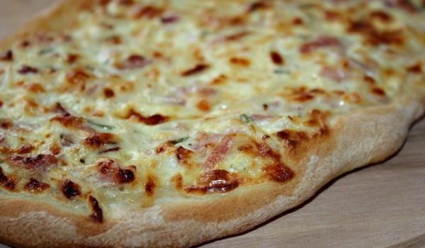 Tarte flambée with bacon and onions